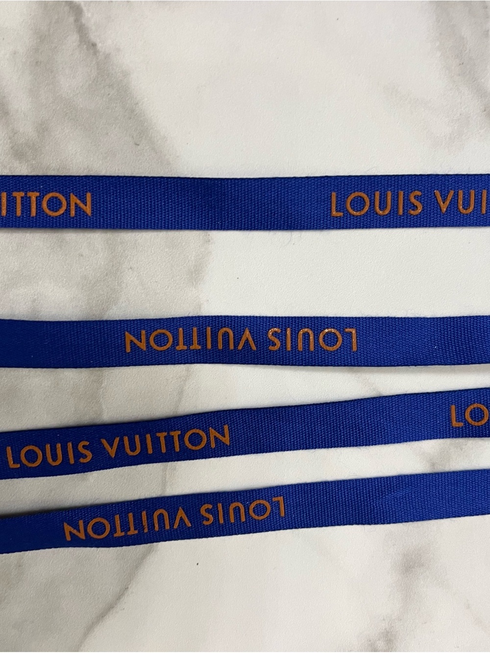 Louis Vuitton cobalt blue ribbon with orange logo